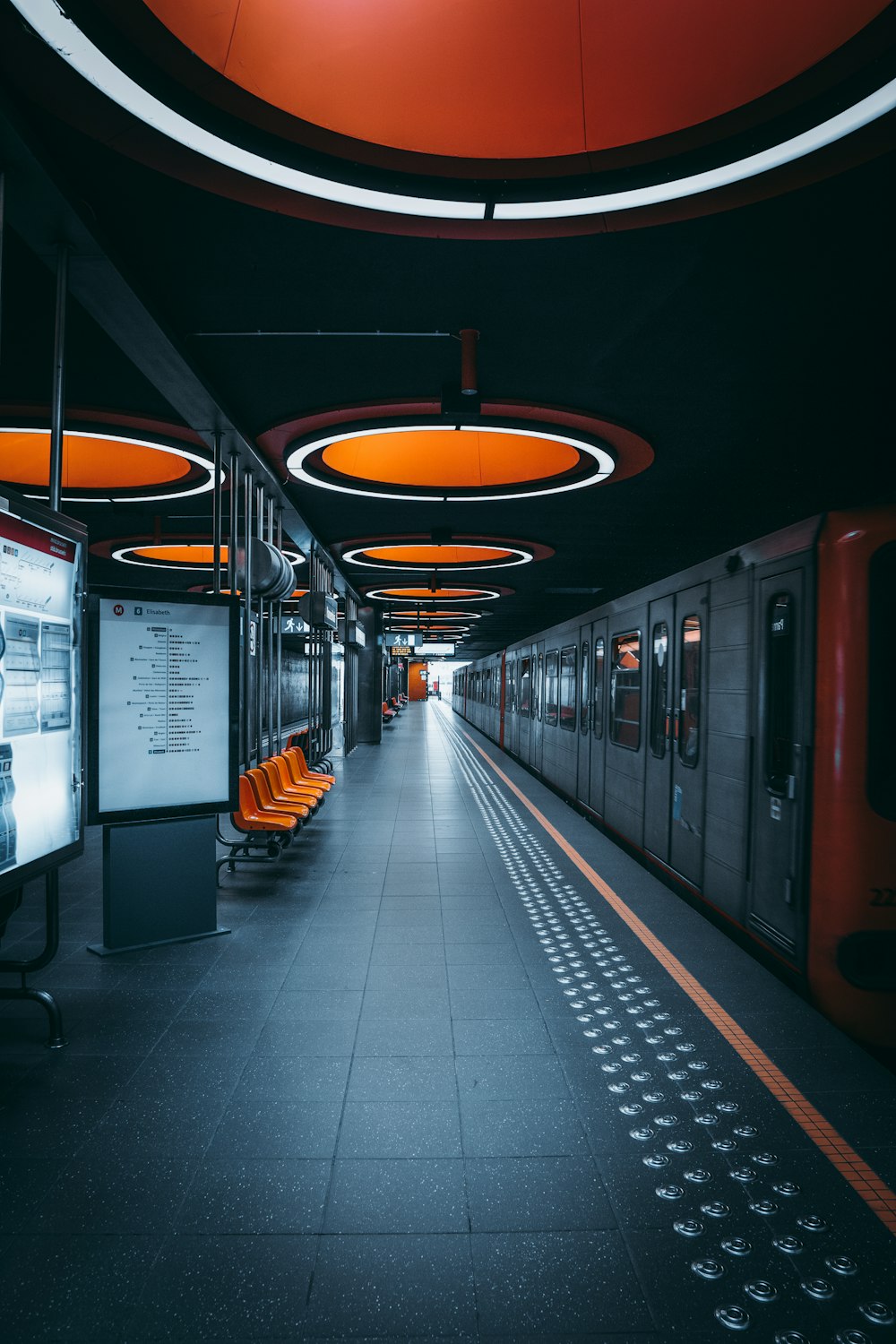 a train station with a train parked next to it