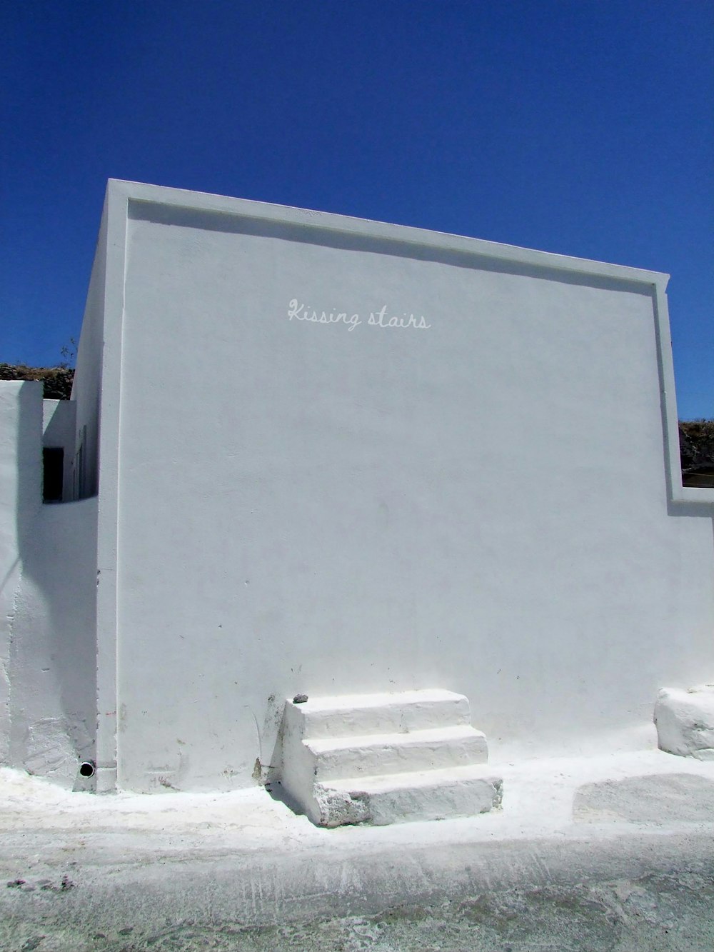 a white building with steps in front of it