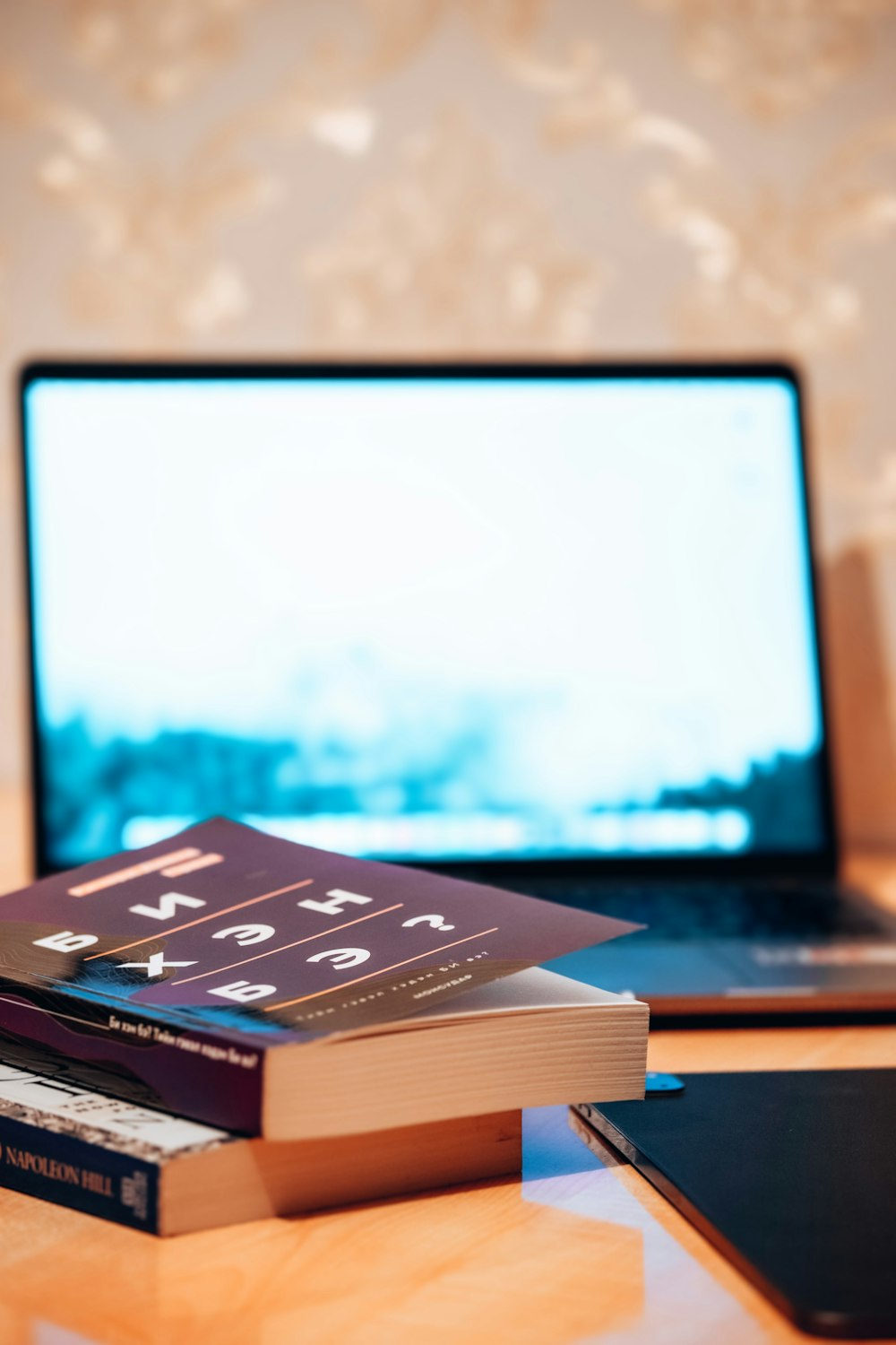 a laptop computer sitting on top of a wooden desk