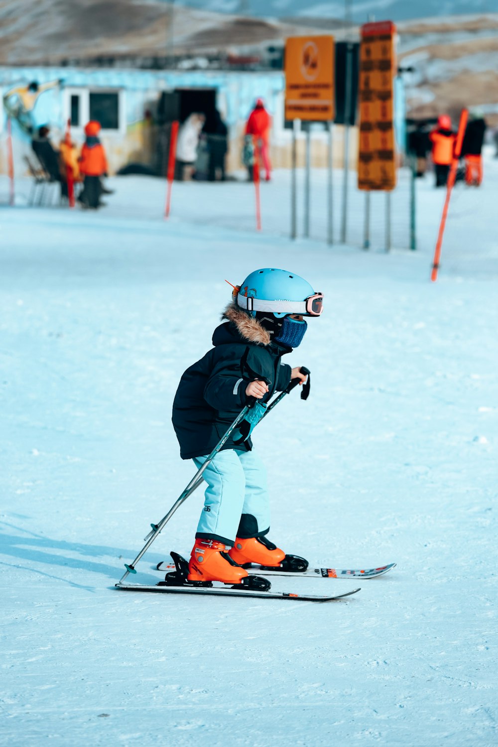 a young child riding skis down a snow covered slope