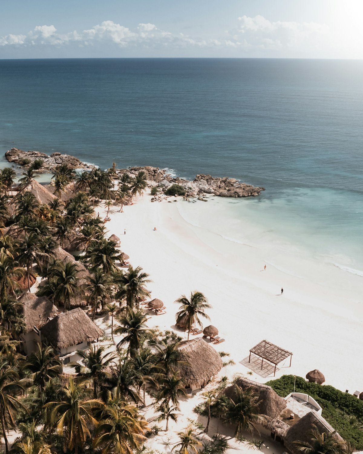 Aldea Zamá Tulum — aerial view of white sand beach with palm trees at the Caribbean edge of the planned neighbourhood