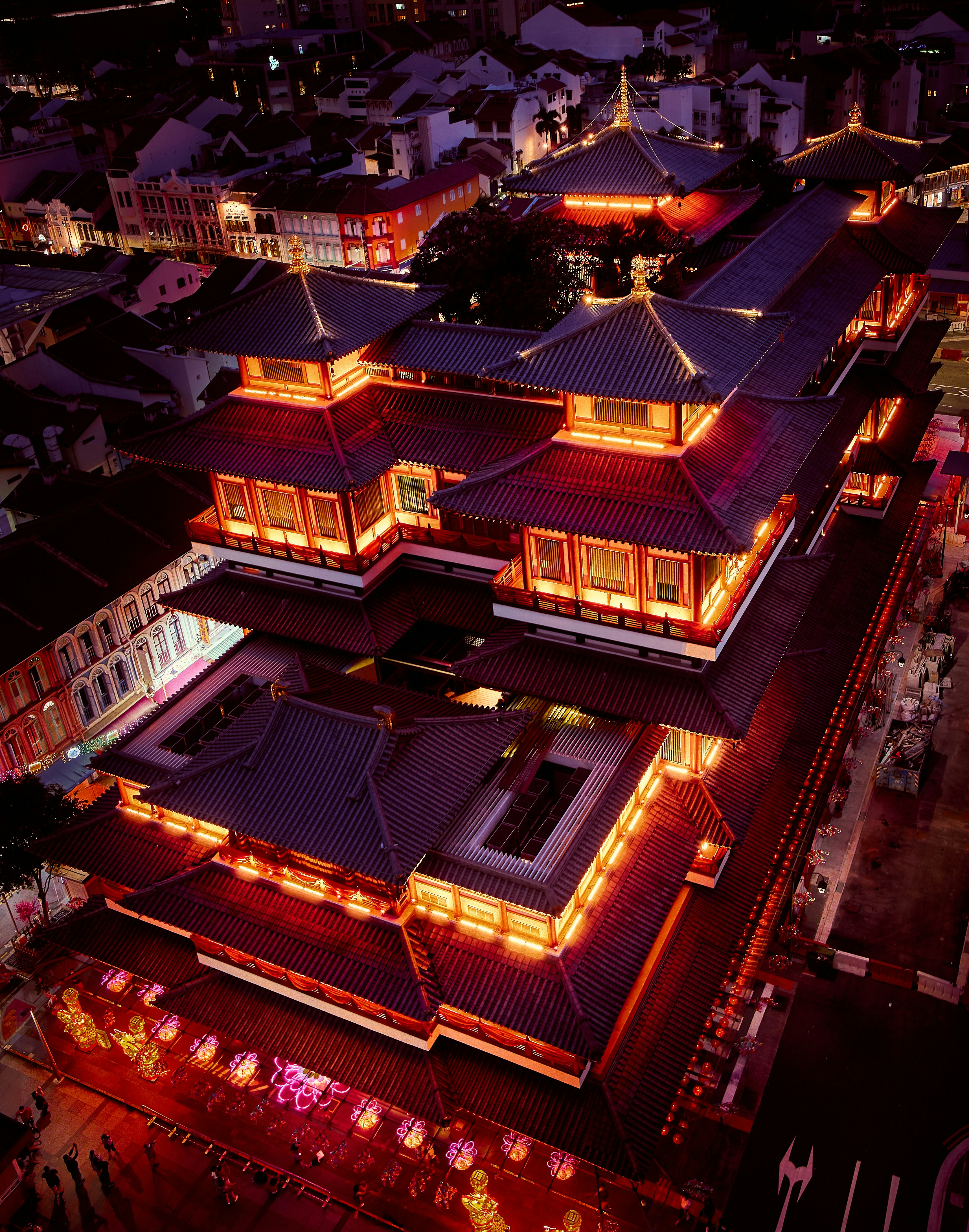 an aerial view of a building lit up at night