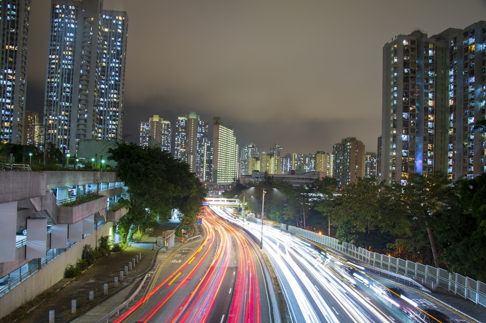 a city street filled with lots of traffic next to tall buildings