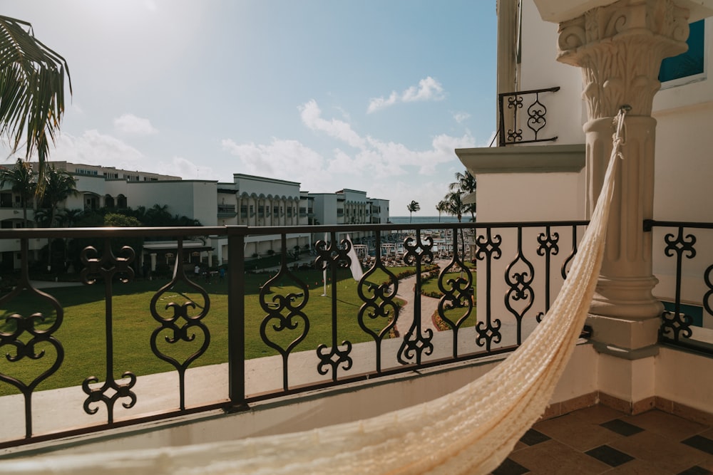 a hammock hanging from a balcony next to a building