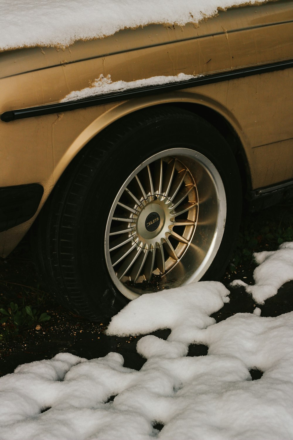a car parked in the snow with snow on the ground