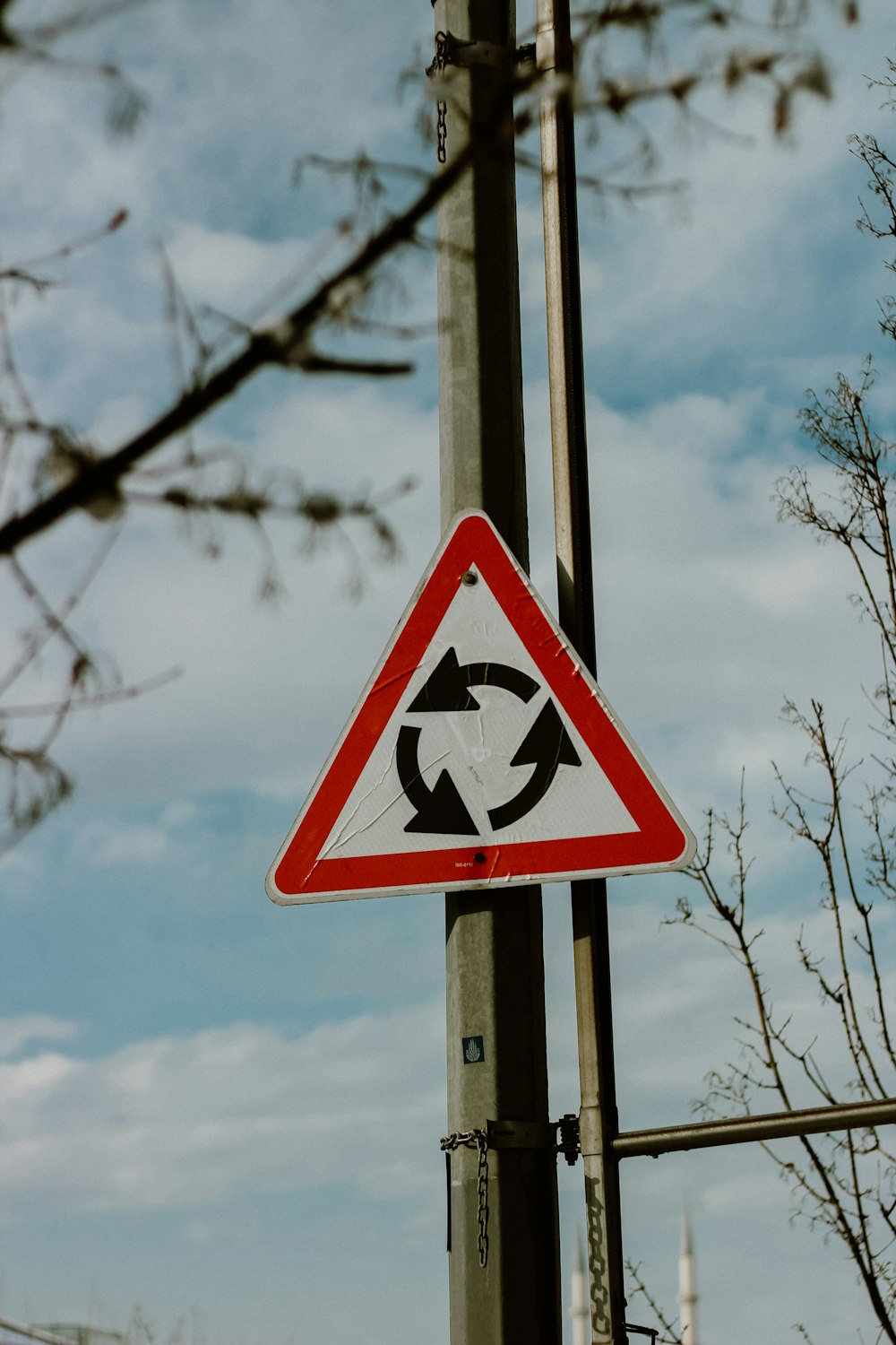 a red white and black sign and some trees