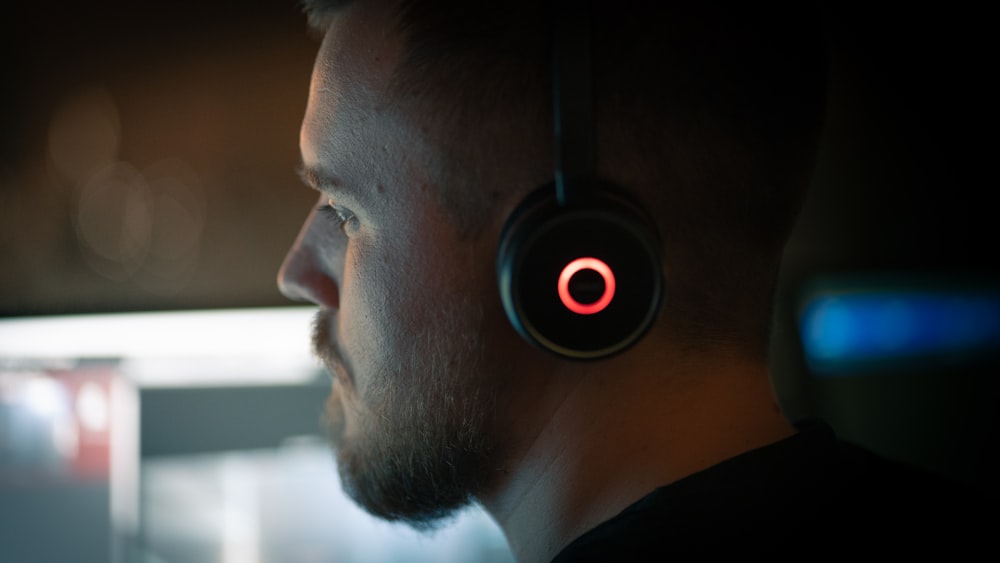 a man wearing headphones in a dark room
