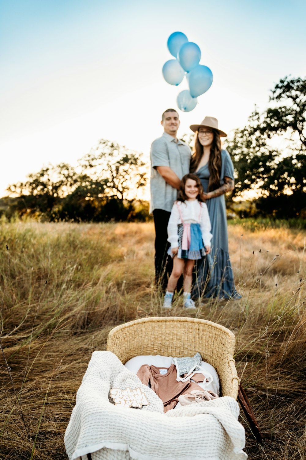 a family standing in a field with balloons