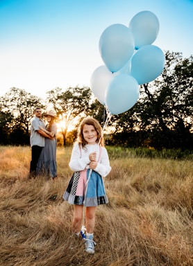 photography poses for family,how to photograph a little girl holding a bunch of white balloons