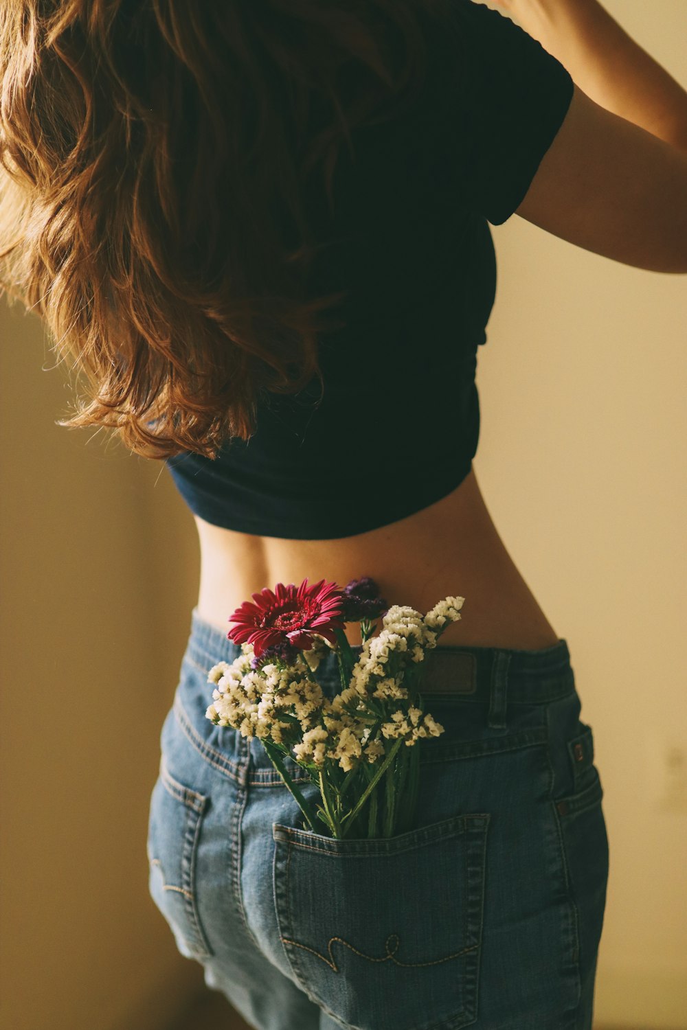 a woman with a flower in her back pocket