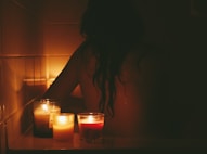 A warm, inviting scene of a woman comfortably using a home testing kit in a softly lit bathroom.