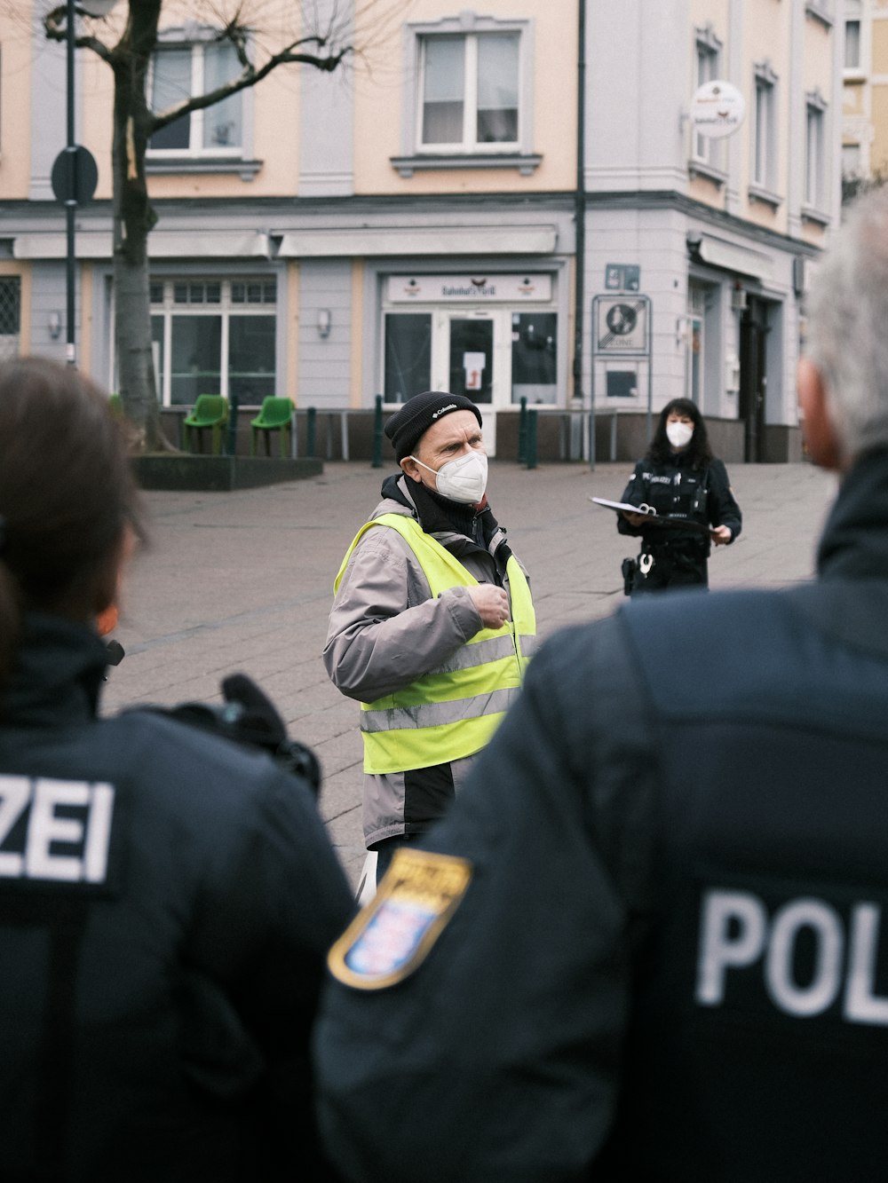 a group of police officers standing in front of a building