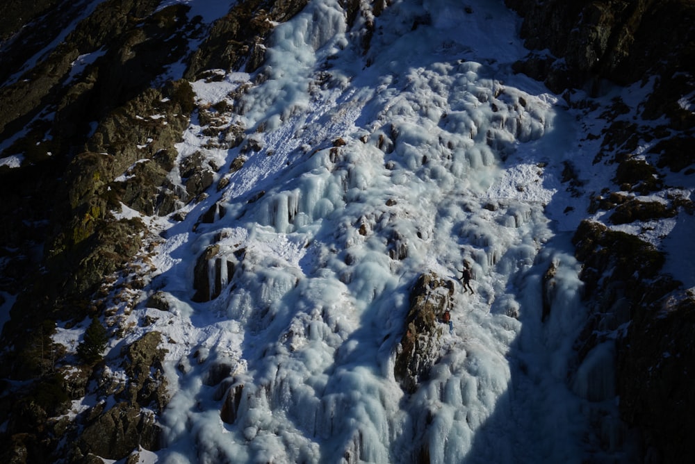 a snow covered mountain side with lots of ice