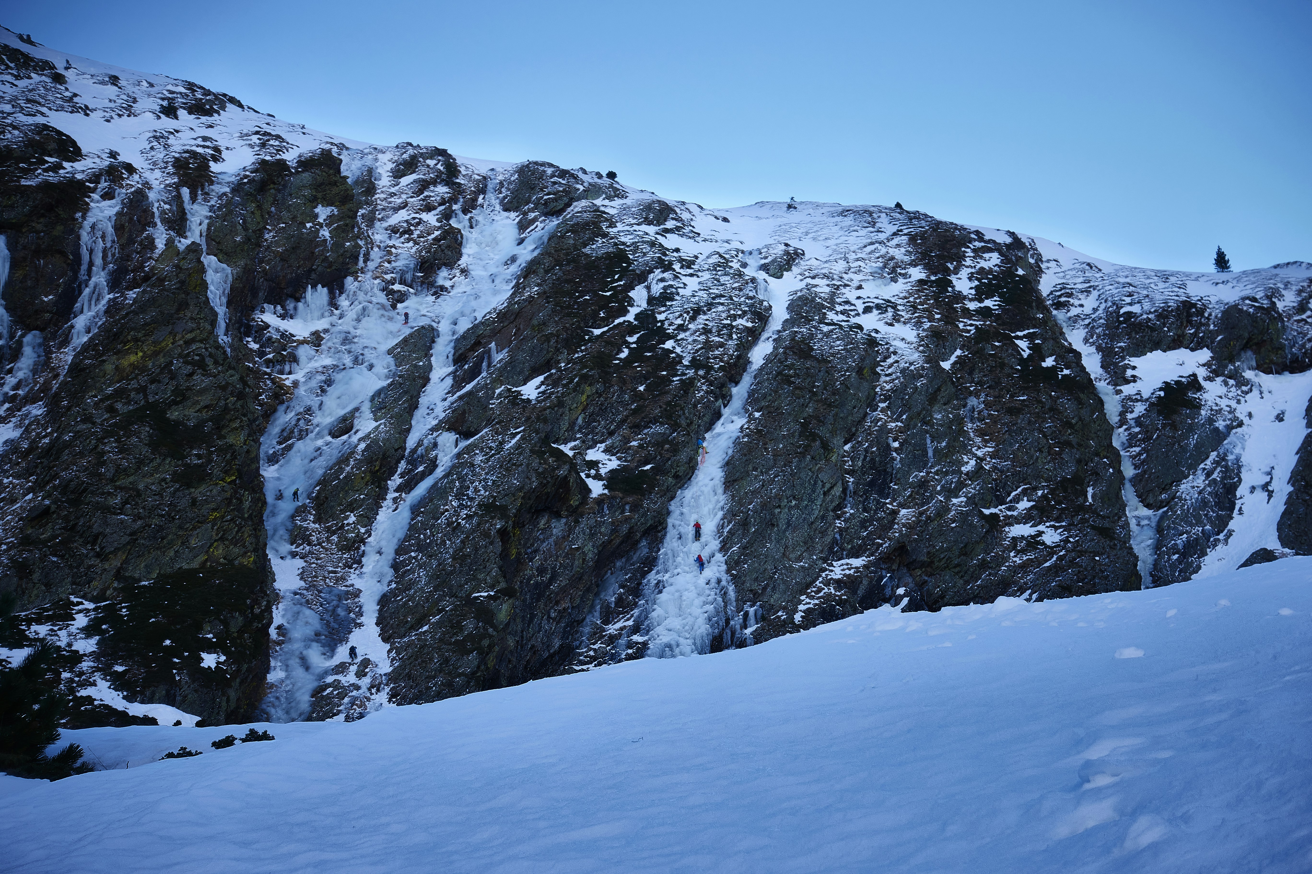 a man riding skis down a snow covered slope