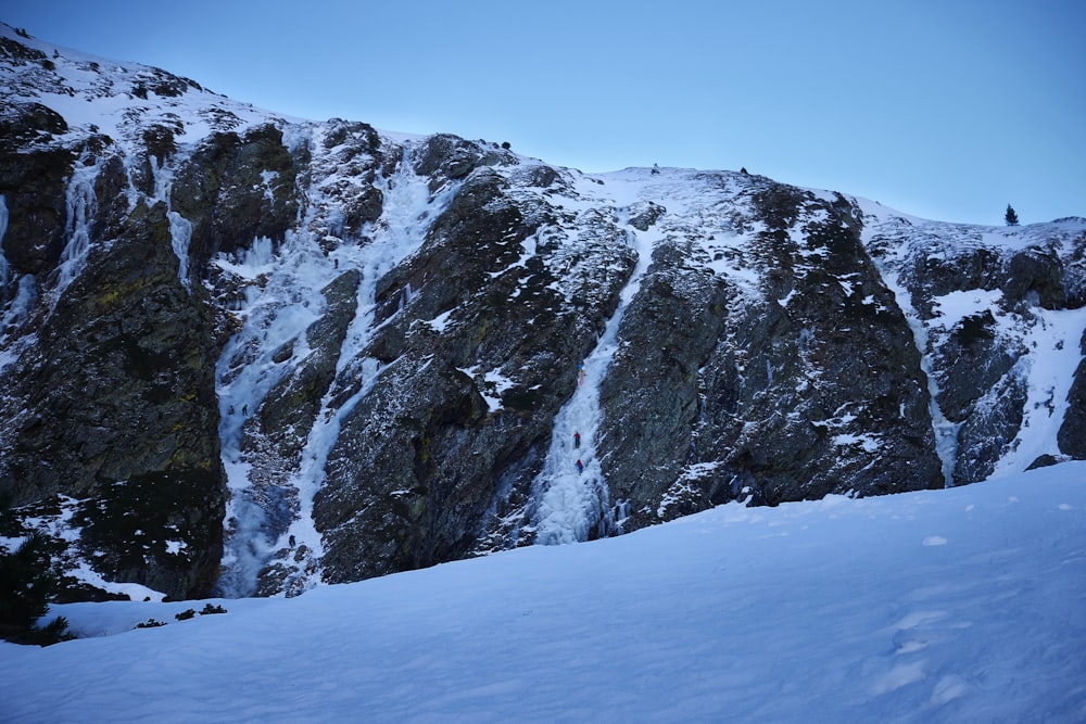 a man riding skis down a snow covered slope