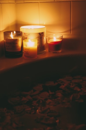A luxurious jacuzzi surrounded by candles and flowers.