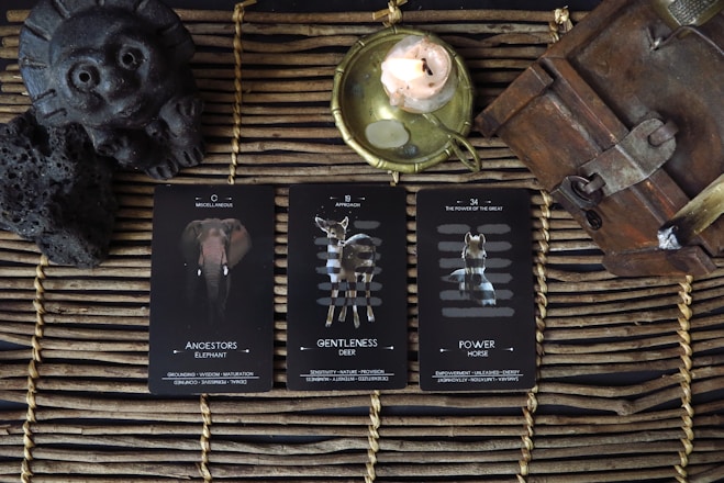 a wicker basket with three cards and a candle