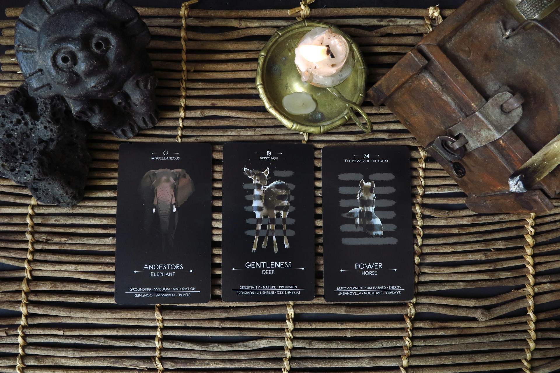 a wicker basket with three cards and a candle