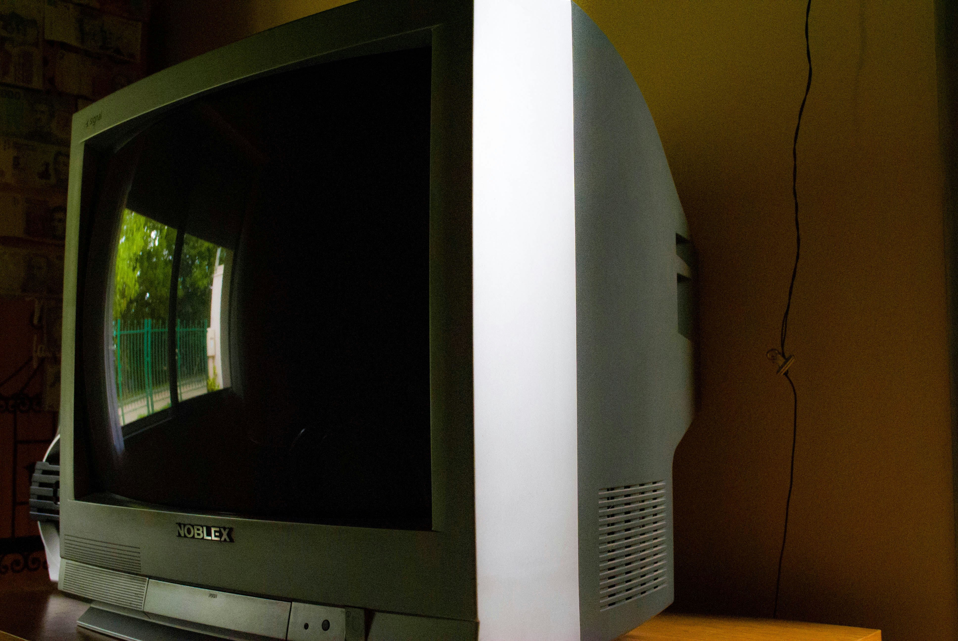 a television sitting on top of a wooden table