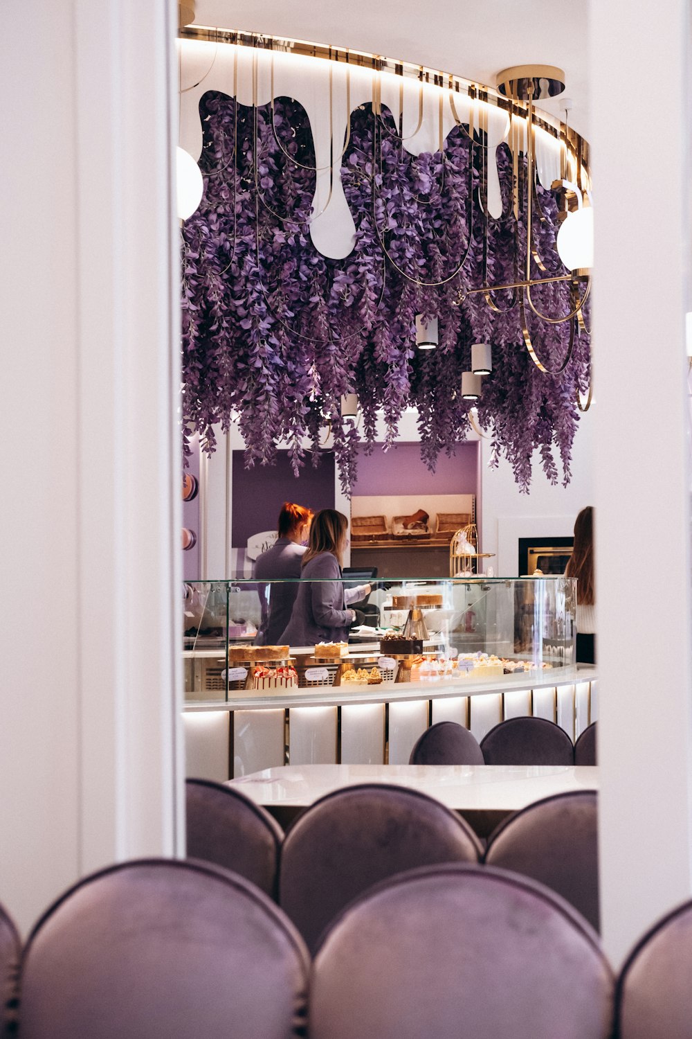a restaurant with purple chairs and a counter
