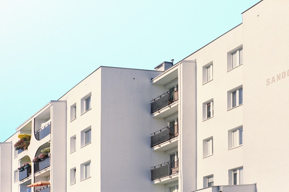 a tall white building with balconies and balconies on the balcon