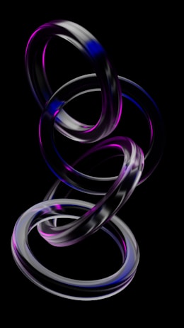 A series of metallic rings intertwined in an abstract form, with a glossy finish and a blend of purple and blue hues. The rings are suspended against a black background, creating a floating effect.