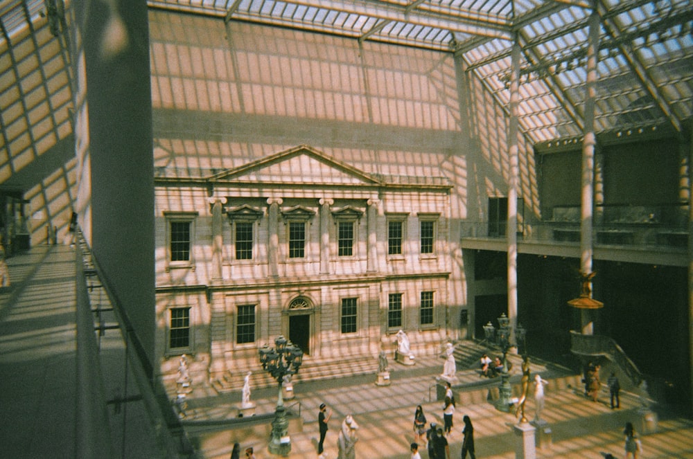 a group of people walking around a building