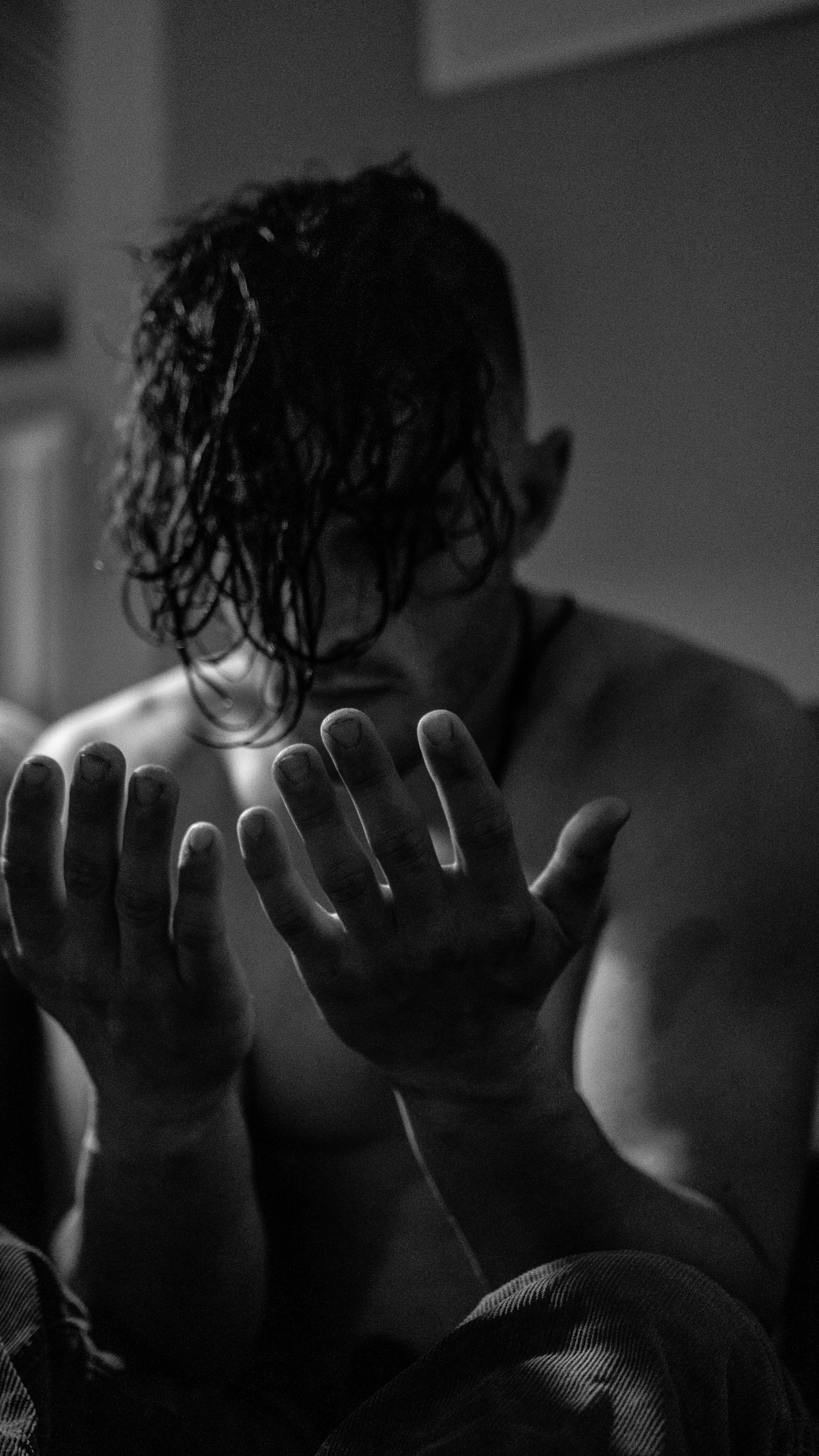 a shirtless man with his hands in the air