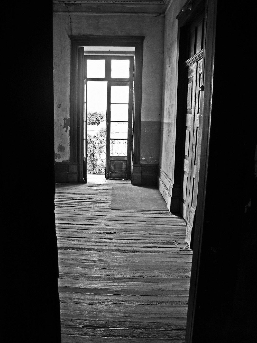 an empty room with a door and a window