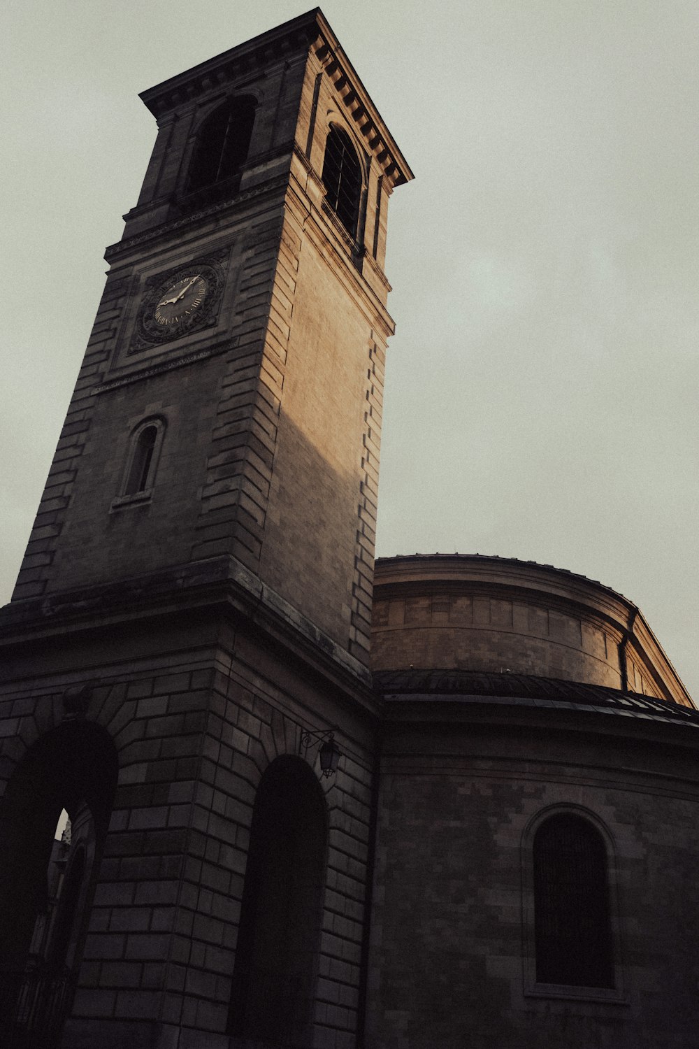 a tall clock tower with a clock on each of it's sides