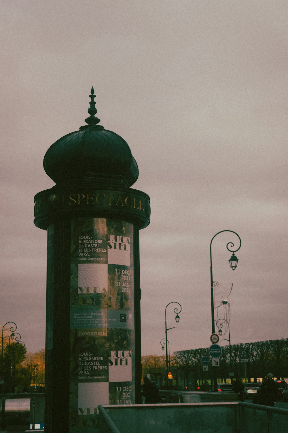 a tall clock tower sitting next to a street