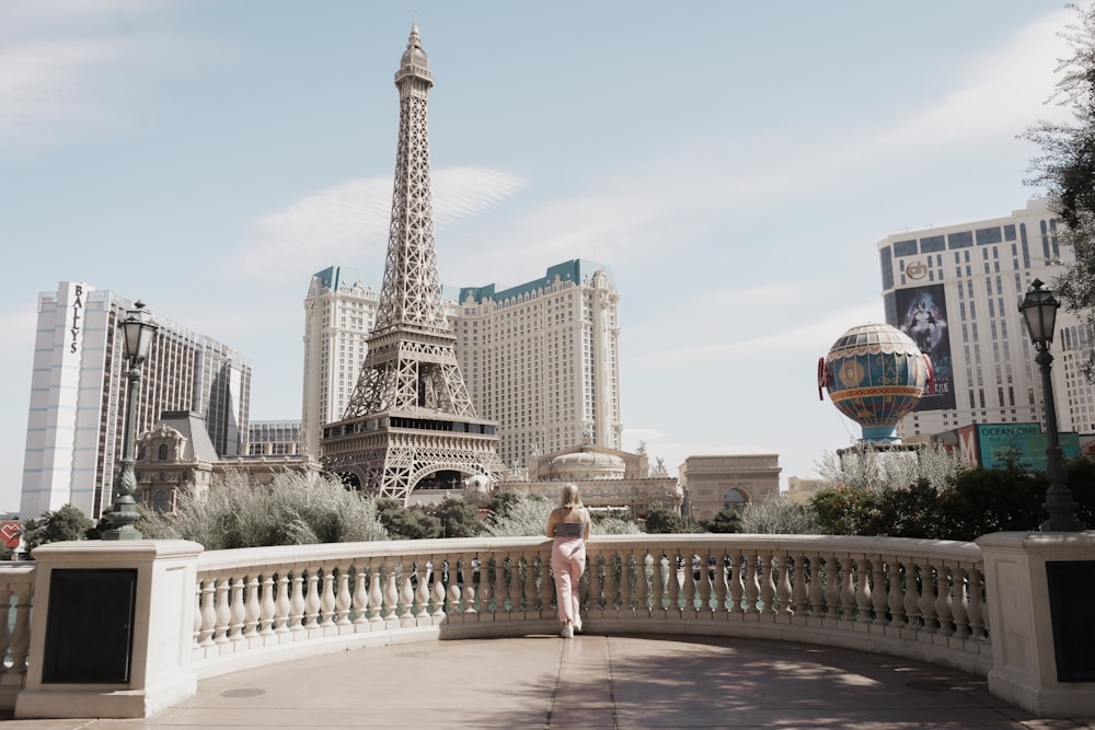 a woman standing in front of the eiffel tower