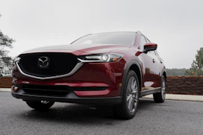 a red mazda cx - 5 parked in a parking lot