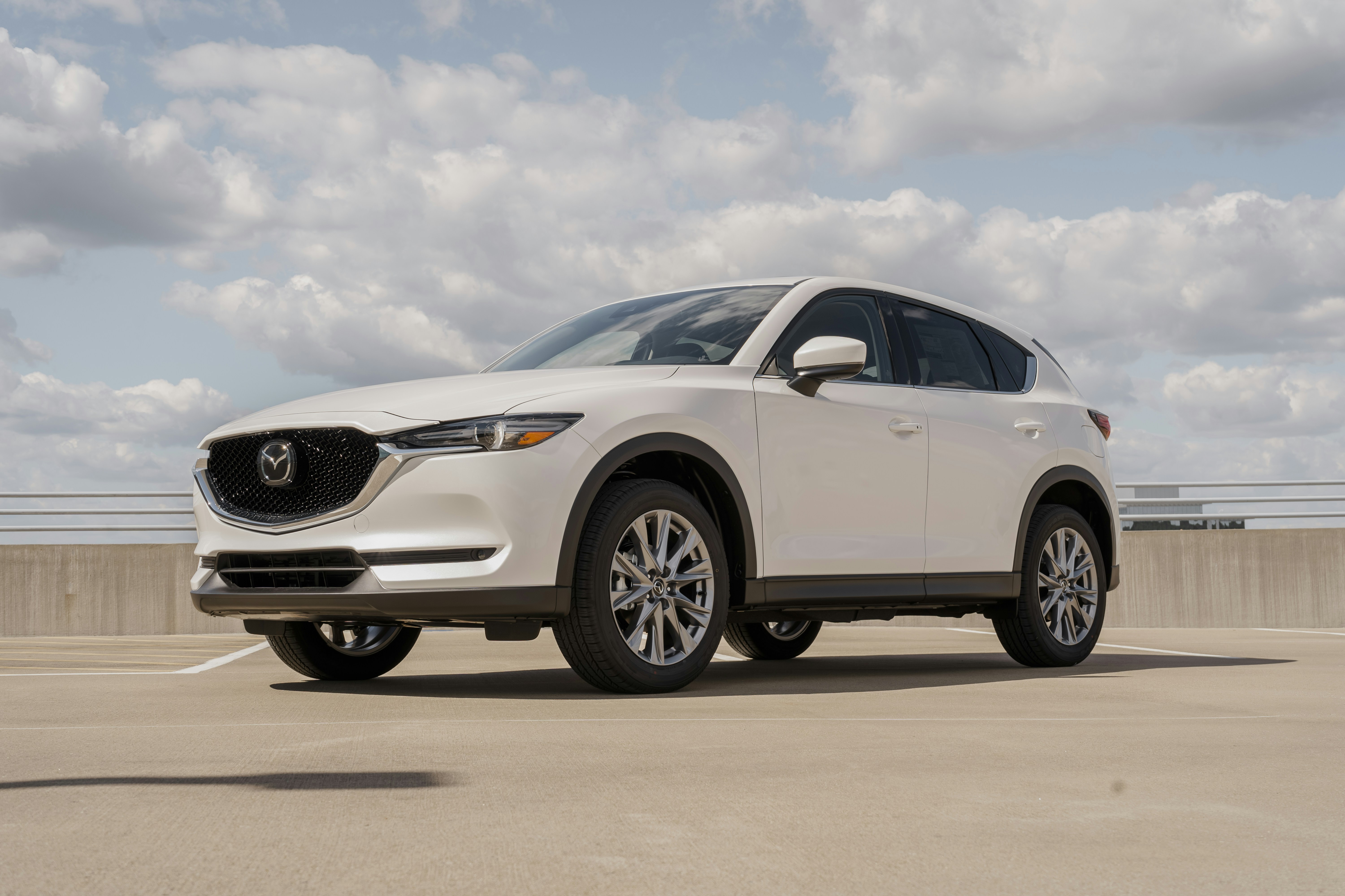 a white mazda cx - 5 parked in a parking lot