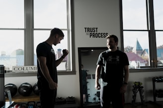 a couple of men standing in front of a window