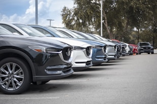 a row of parked cars in a parking lot