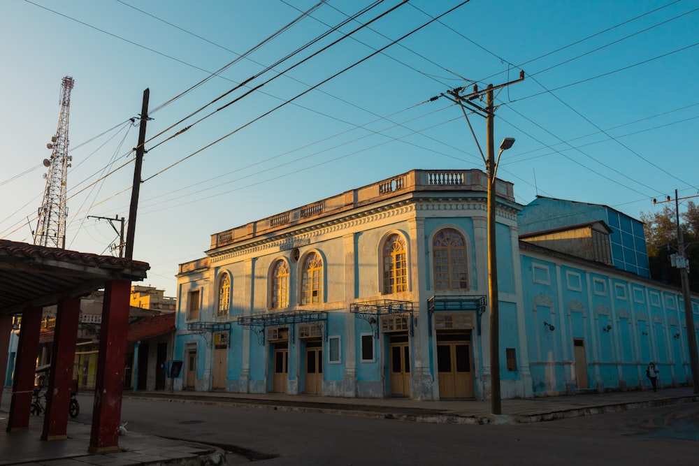 a blue and white building sitting on the side of a road