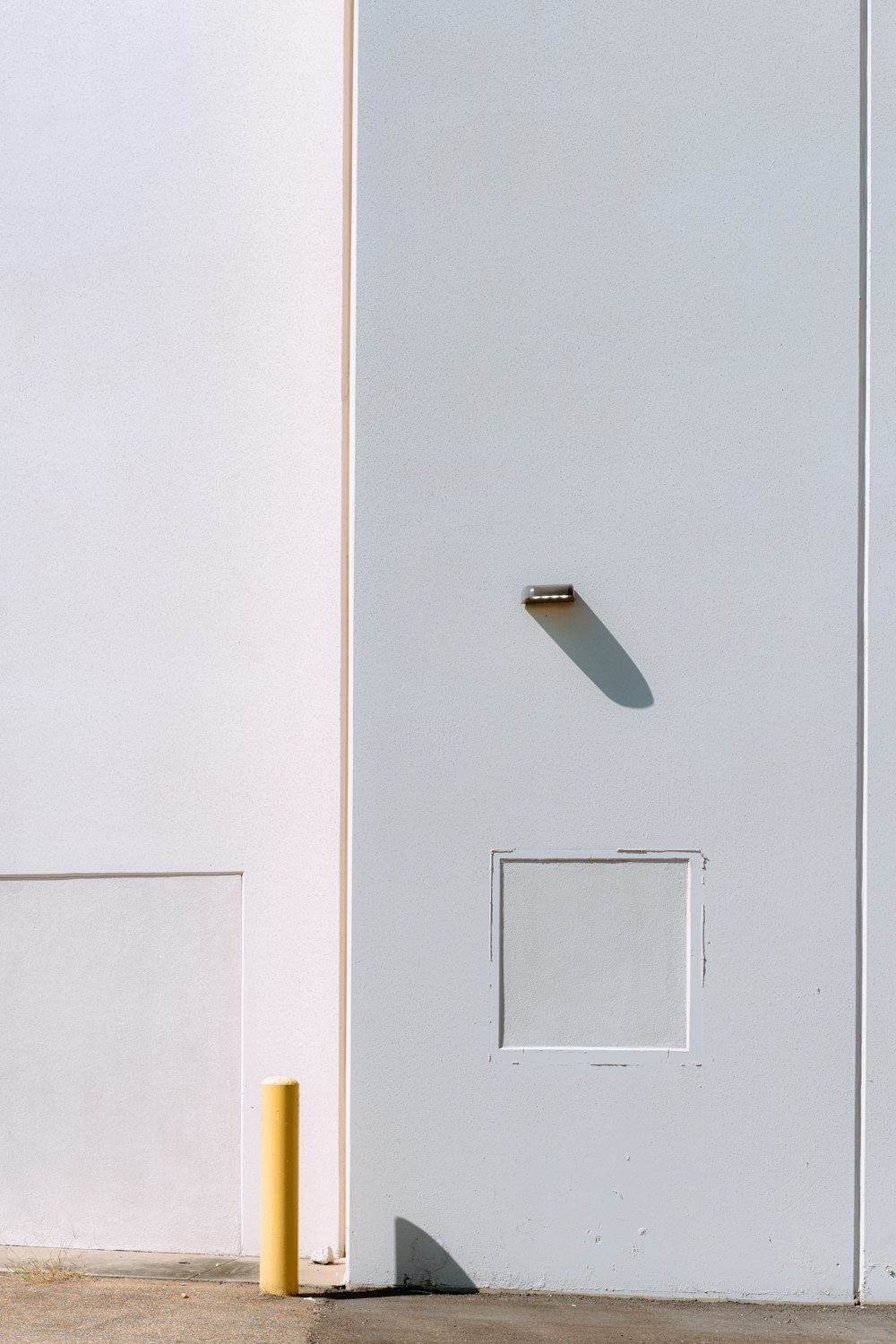 a white door with a yellow pole in front of it