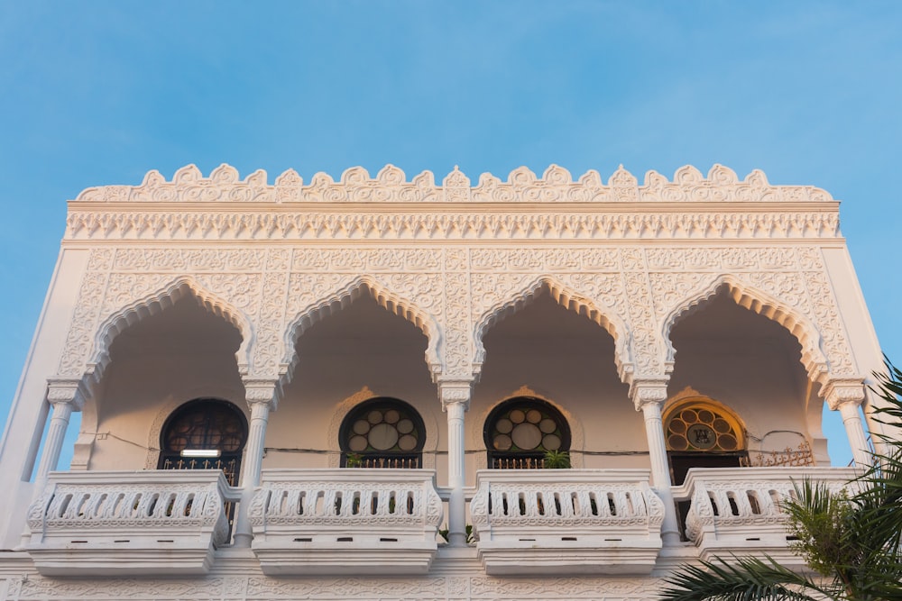 a white building with a balcony and balconies