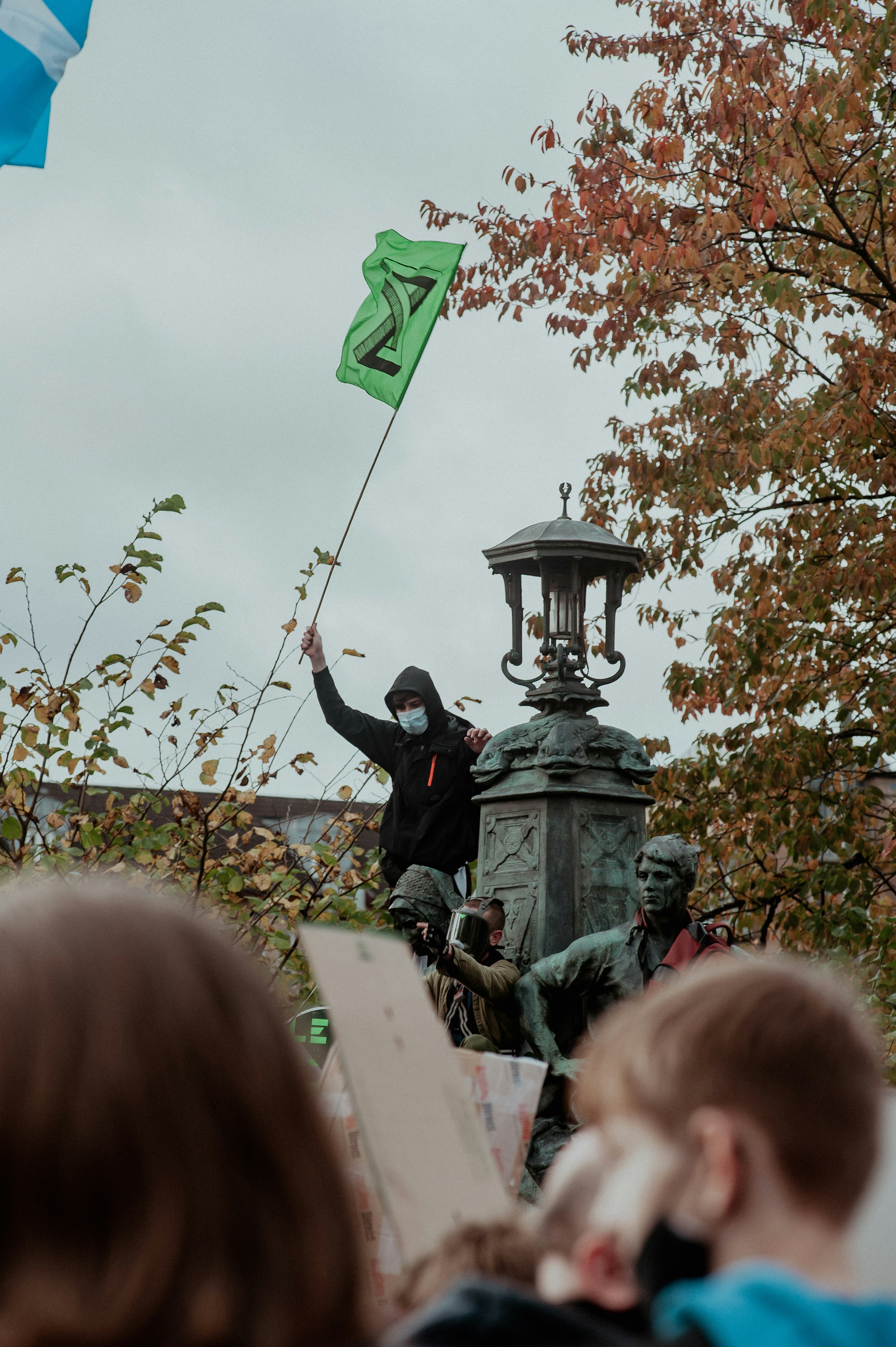 Ein Mann, der eine Flagge auf einer Statue hält