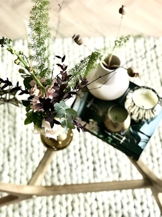 A rustic wooden coffee table adorned with fresh flowers and candles.
