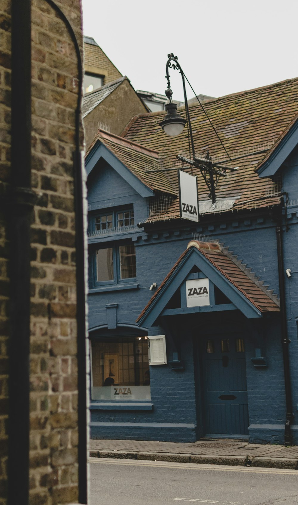 a blue building with a clock on the front of it