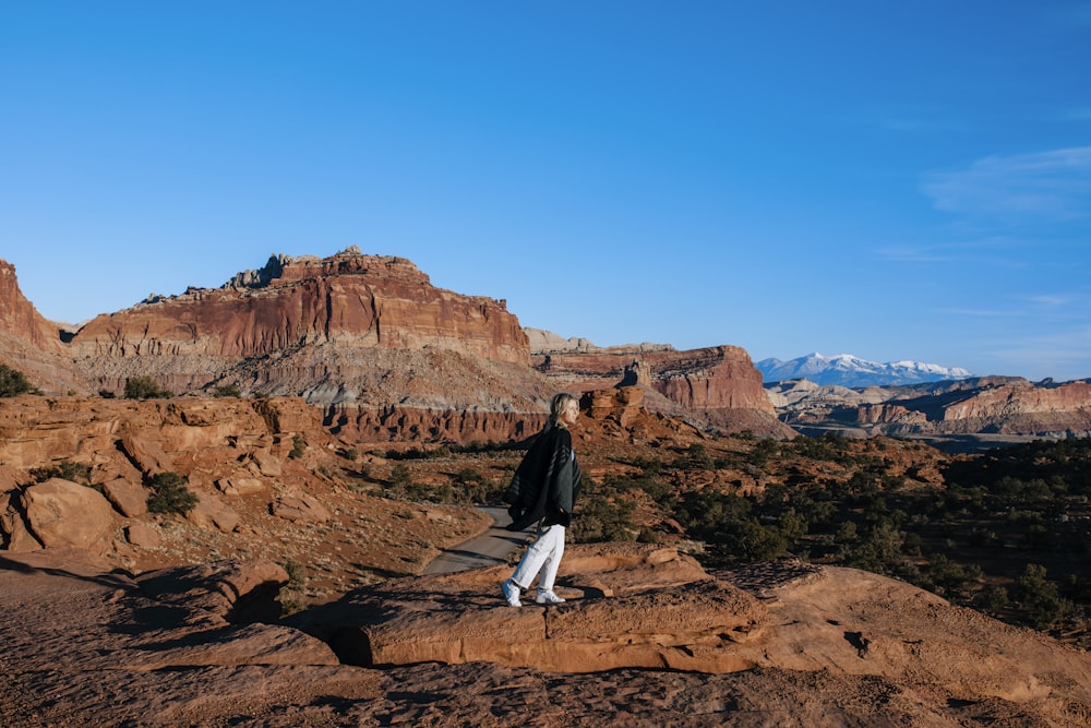 a man standing on top of a rock formation