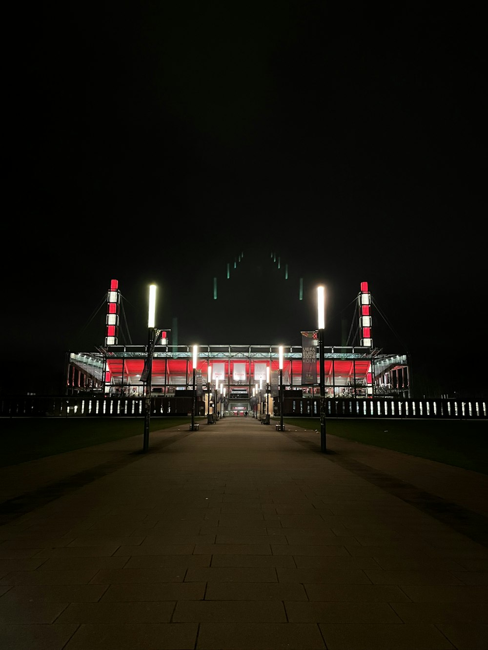 a stadium lit up at night with lights on