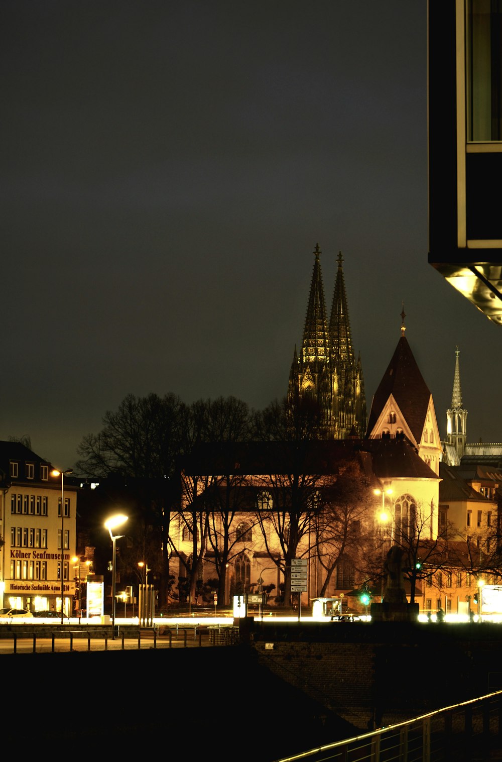a city at night with a church lit up