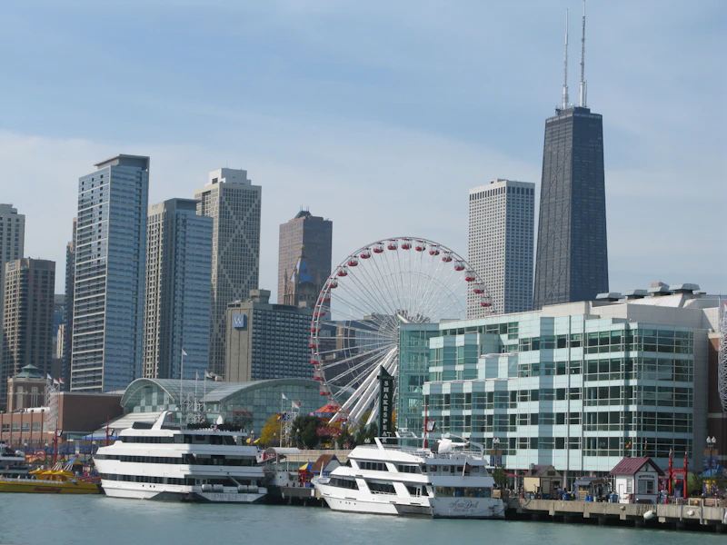 Navy Pier's Ferris wheel with yachts and buildings along the Chicago lakefront