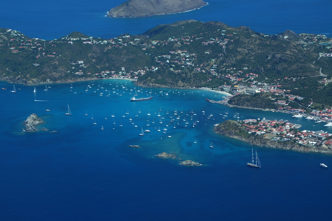 an aerial view of a small island with boats in the water, St. Kitts and Nevis from above - many yachts!