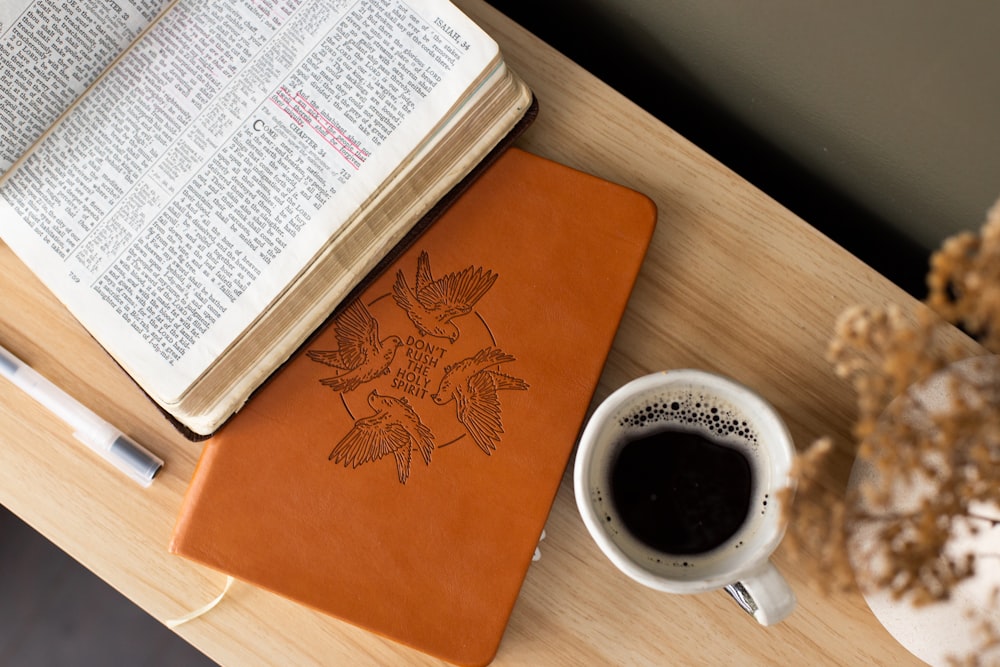 a book and a cup of coffee on a table