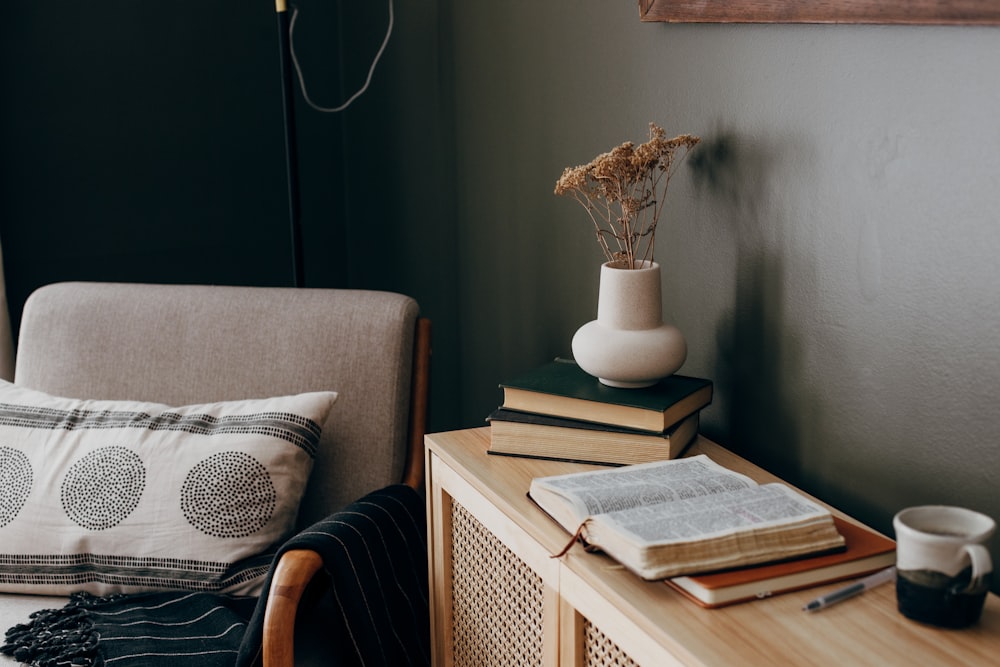 a stack of books sitting on top of a wooden table