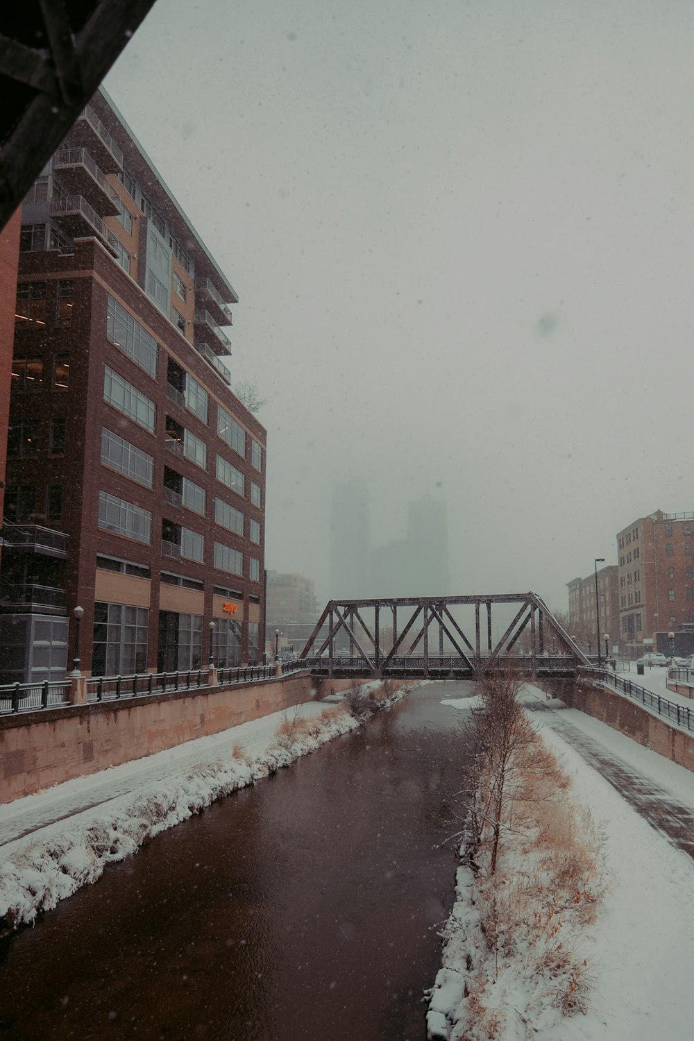 a river running through a city next to tall buildings